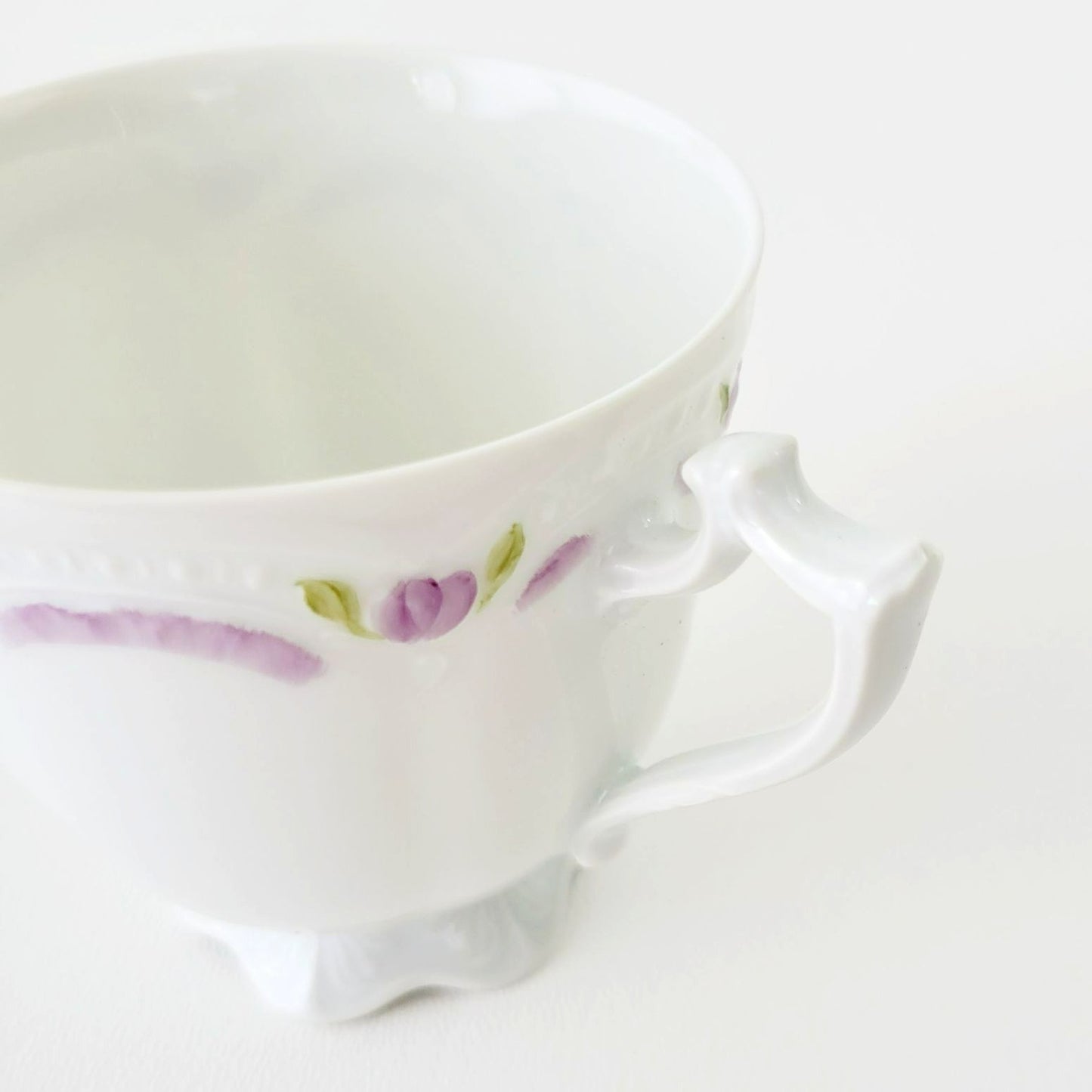 Hutschenreuther Viktoria Teacup & Saucer, White Embossed with Hand Painted Purple & Green Painted Floral, Artist Signed, Germany