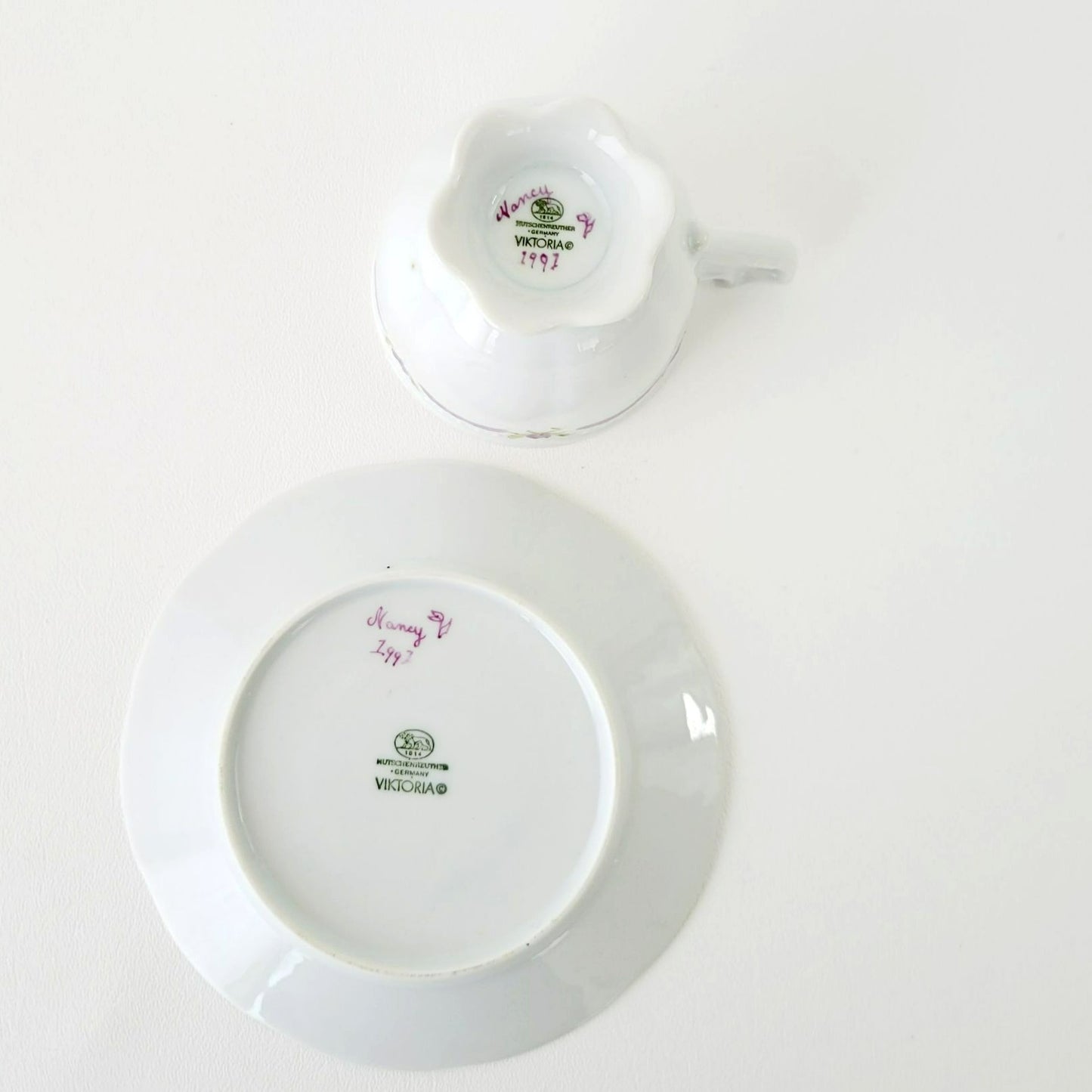Hutschenreuther Viktoria Teacup & Saucer, White Embossed with Hand Painted Purple & Green Painted Floral, Artist Signed, Germany
