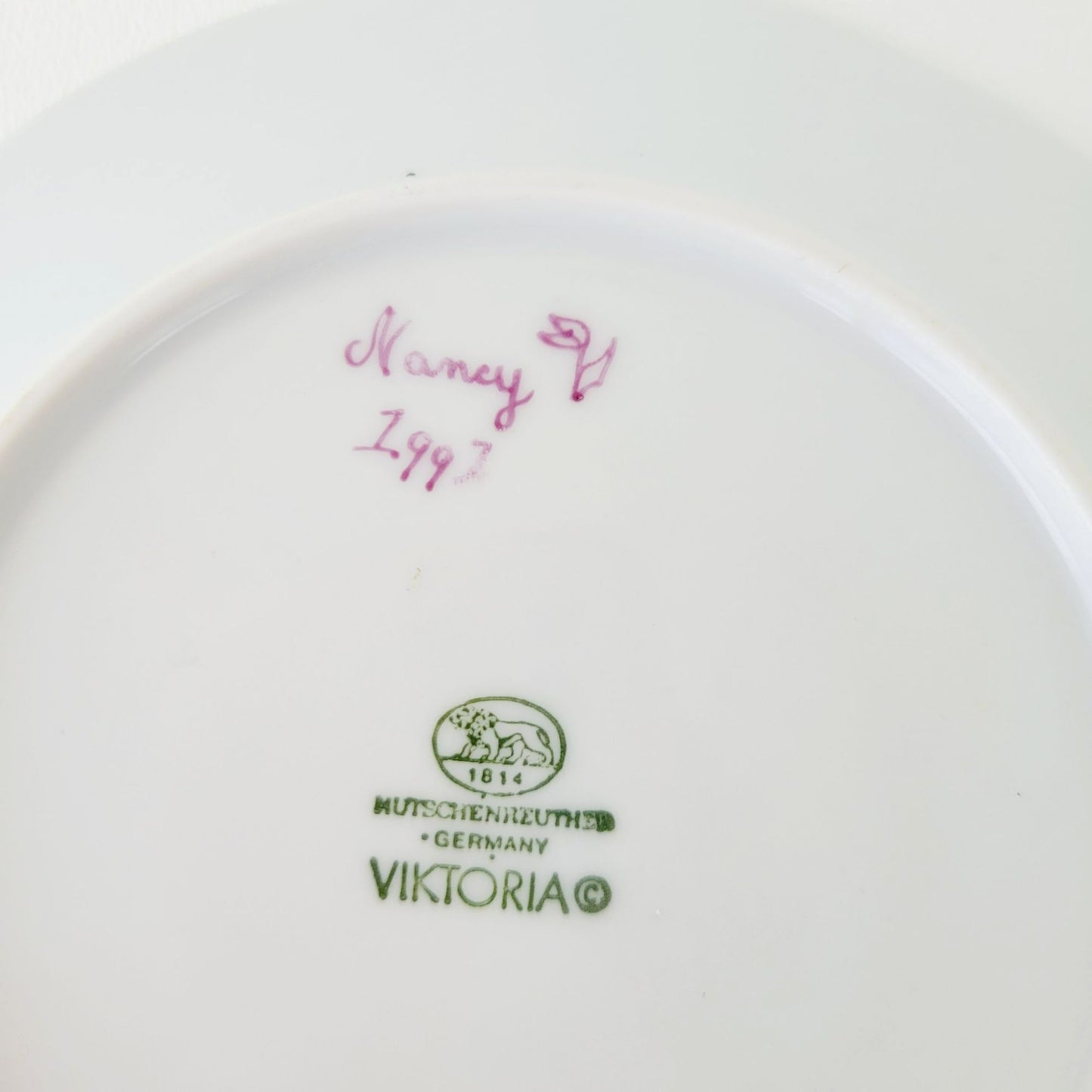 Hutschenreuther Viktoria Teacup & Saucer, White Embossed with Hand Painted Purple & Green Painted Floral, Artist Signed, Germany