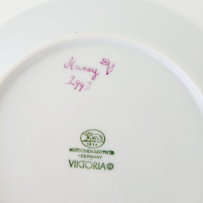 Hutschenreuther Viktoria Teacup & Saucer, White Embossed with Hand Painted Purple & Green Painted Floral, Artist Signed, Germany